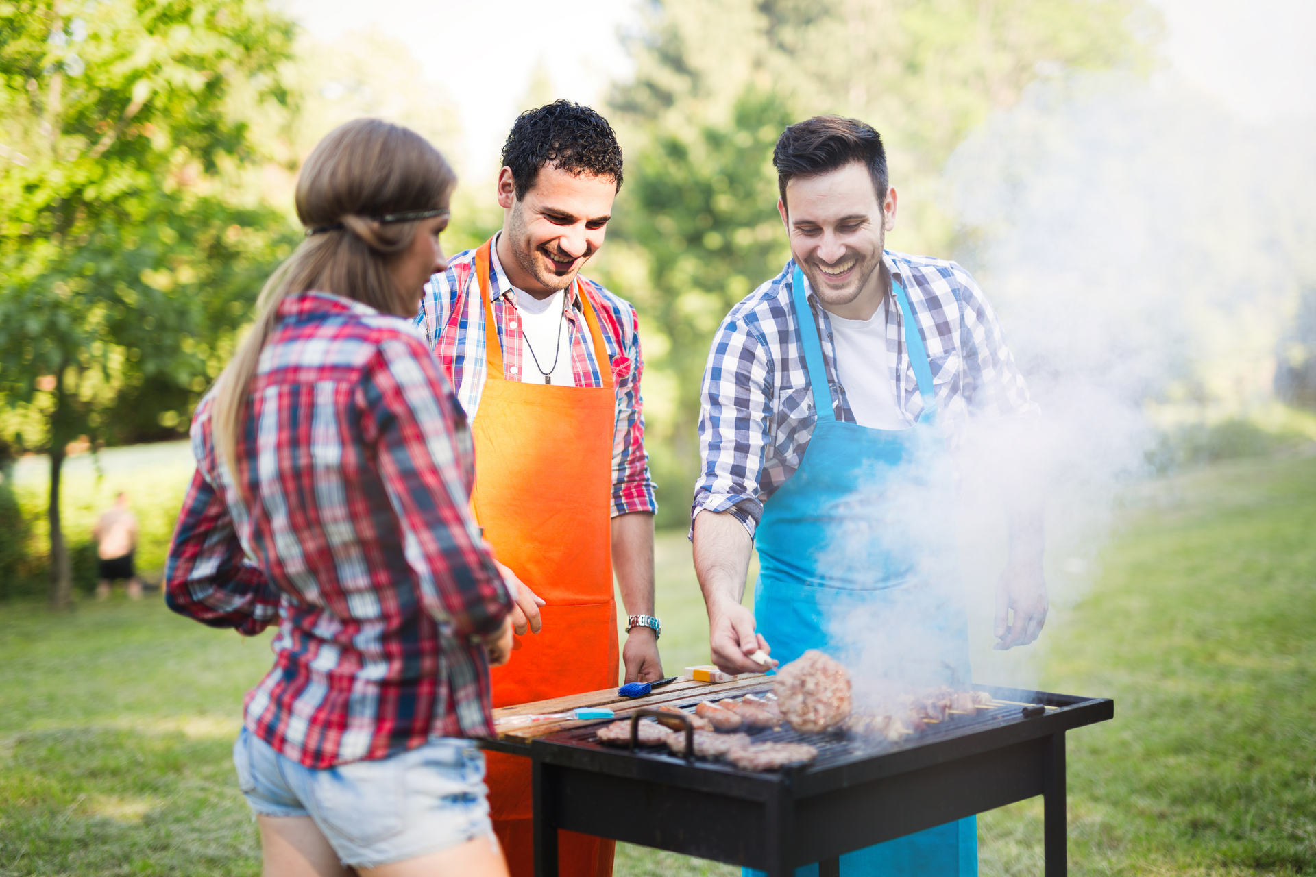 friends-having-a-barbecue-party-in-nature-PRFECV8.jpg